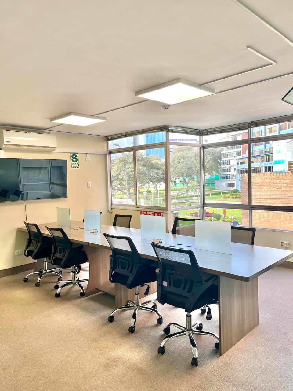 Profesionales trabajando en el área compartida de coworking en San Isidro